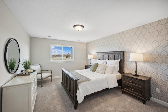 bedroom featuring a textured ceiling and light carpet