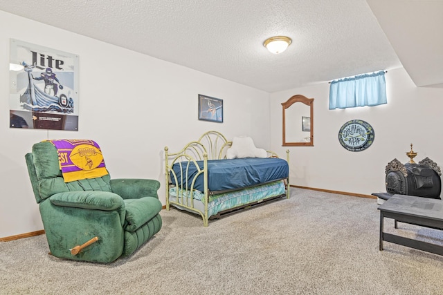 carpeted bedroom featuring baseboards and a textured ceiling