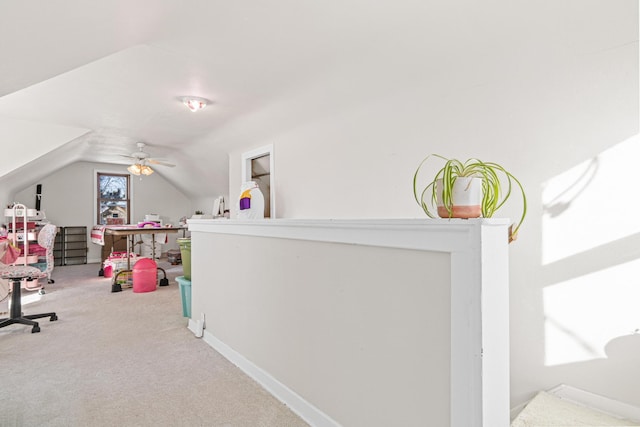 office area with vaulted ceiling, carpet flooring, baseboards, and ceiling fan