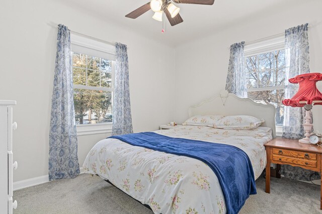 carpeted bedroom featuring baseboards and ceiling fan