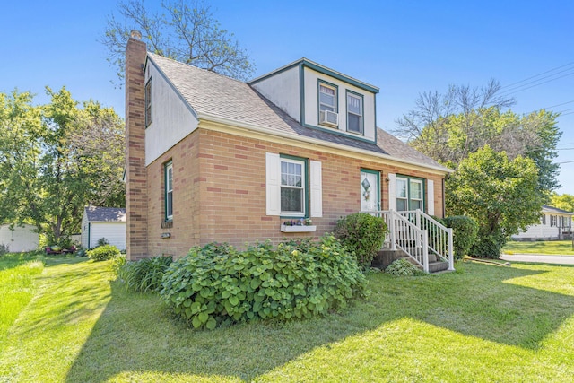 view of front of property with cooling unit, a front yard, a shingled roof, brick siding, and a chimney