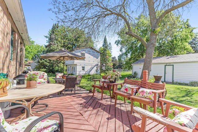 deck with outdoor dining area and a lawn