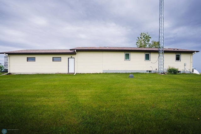 back of property featuring a lawn