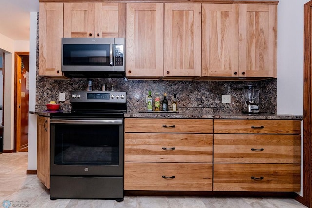 kitchen with backsplash, light tile flooring, and stainless steel appliances