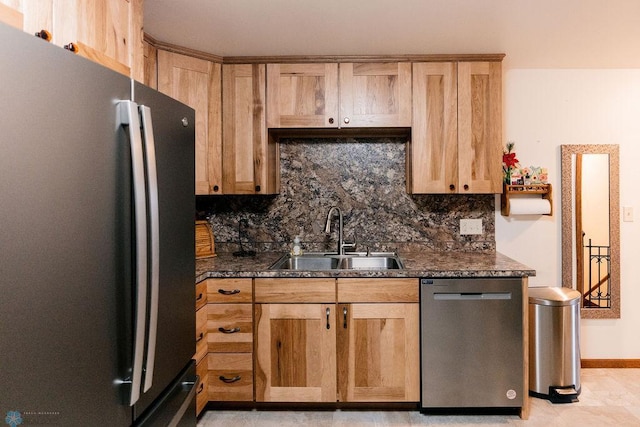 kitchen with dark stone counters, tasteful backsplash, stainless steel appliances, light tile floors, and sink