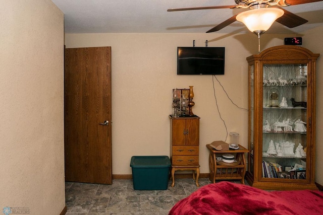 bedroom featuring tile floors and ceiling fan