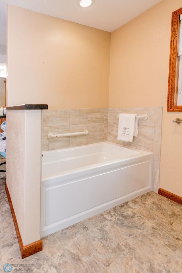 bathroom featuring a bath to relax in and tile floors