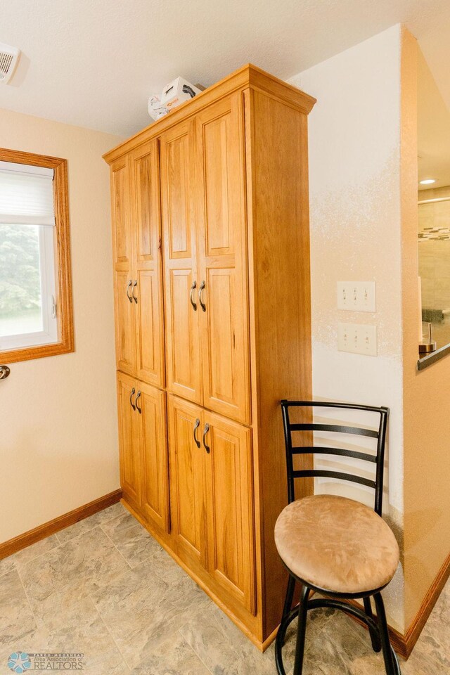 interior space with baseboards and visible vents