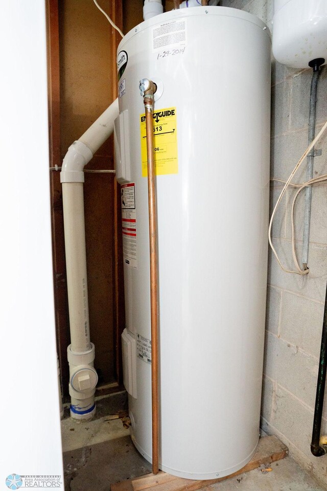utility room featuring water heater