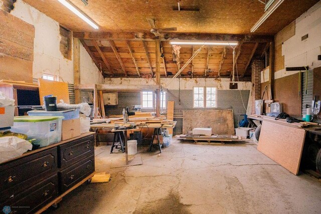 miscellaneous room with a workshop area and vaulted ceiling