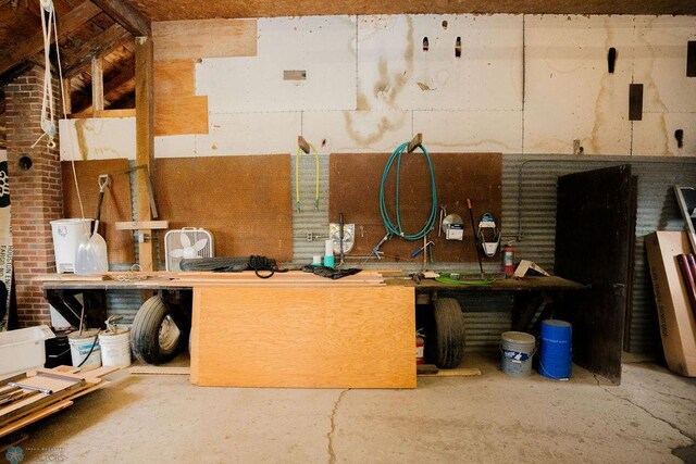 misc room featuring a workshop area and concrete flooring