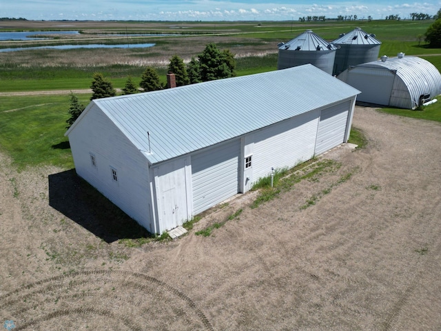 birds eye view of property featuring a water view and a rural view