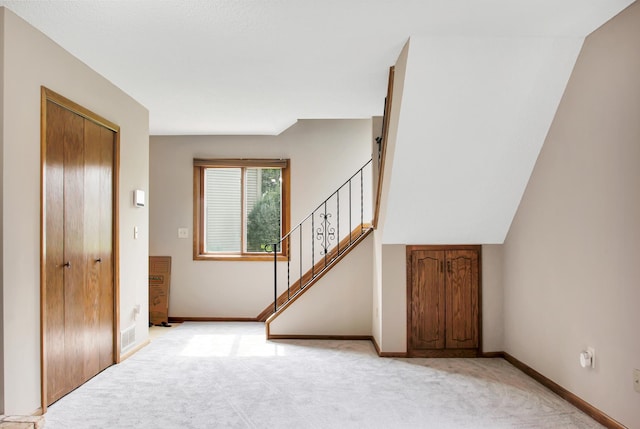 view of carpeted foyer entrance