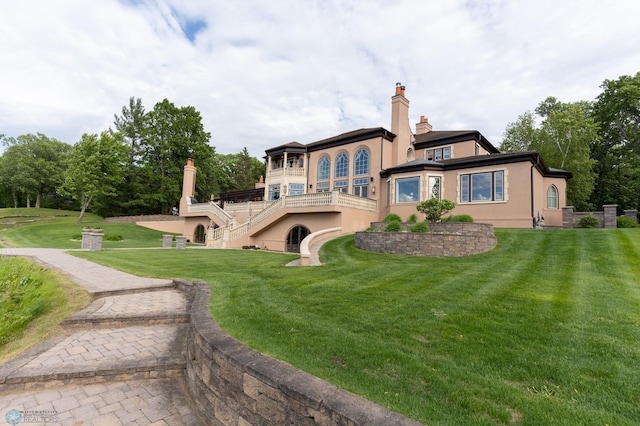 rear view of property with a lawn