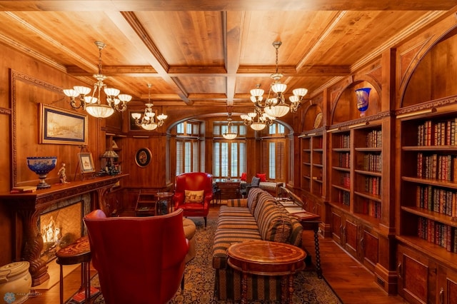 living area with coffered ceiling, hardwood / wood-style flooring, wood ceiling, and a chandelier