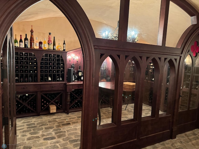 wine room with vaulted ceiling