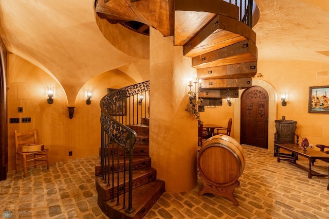 stairway featuring lofted ceiling