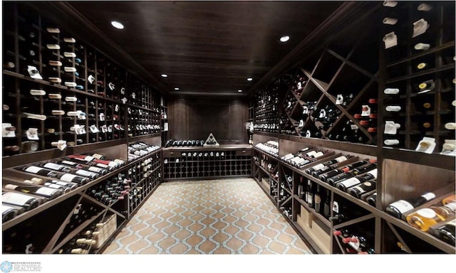 wine room featuring tile floors and wood ceiling