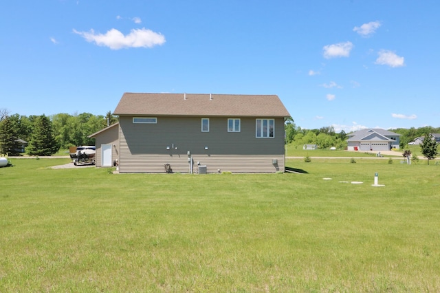 rear view of property featuring a yard