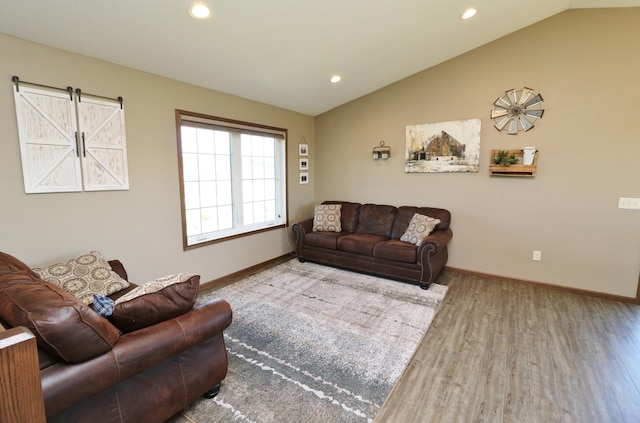 living room with wood-type flooring and lofted ceiling