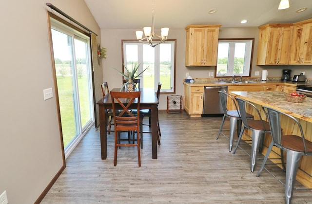 kitchen with dishwasher, hanging light fixtures, light wood-type flooring, and a notable chandelier