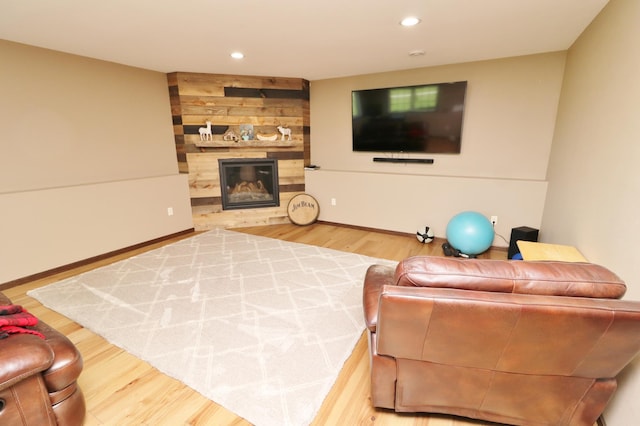 living room with hardwood / wood-style floors and a large fireplace