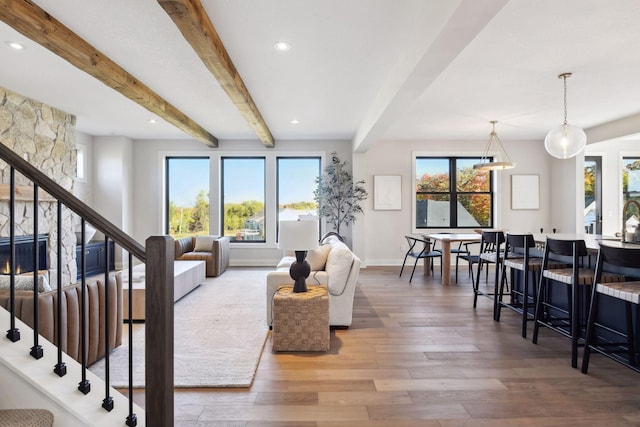 living room featuring beam ceiling and hardwood / wood-style floors