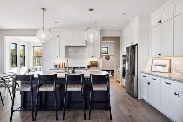 kitchen with white cabinetry, dark hardwood / wood-style floors, pendant lighting, and stainless steel fridge with ice dispenser