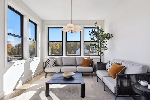 sunroom / solarium with a notable chandelier and a healthy amount of sunlight