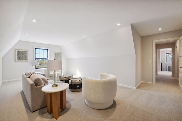 living area with lofted ceiling and light colored carpet