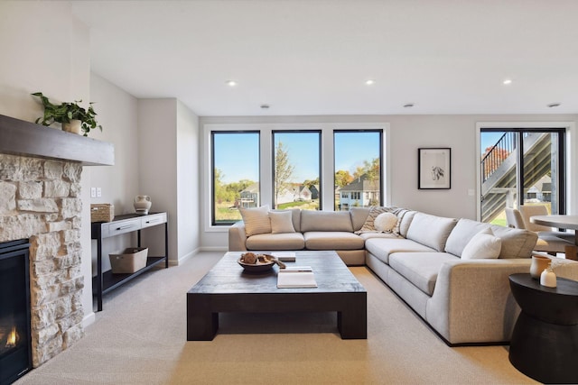 carpeted living room with a fireplace