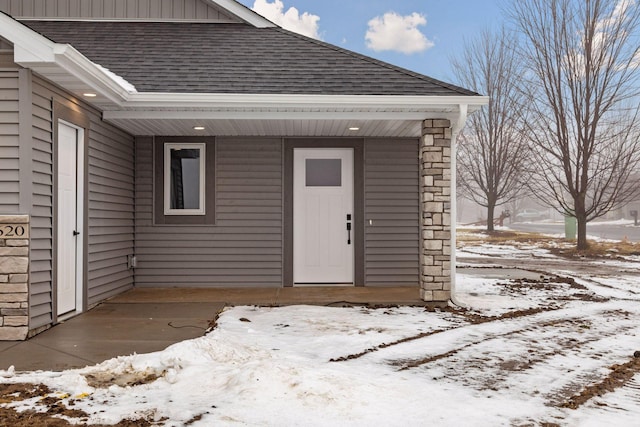 view of snow covered property entrance