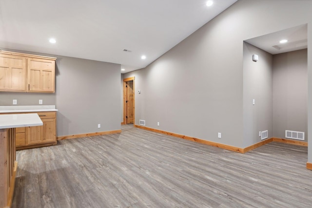 kitchen with light brown cabinets and light hardwood / wood-style flooring