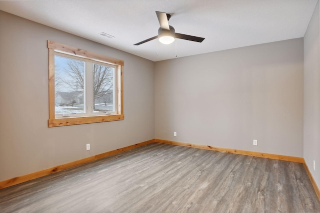 empty room featuring light wood-type flooring and ceiling fan