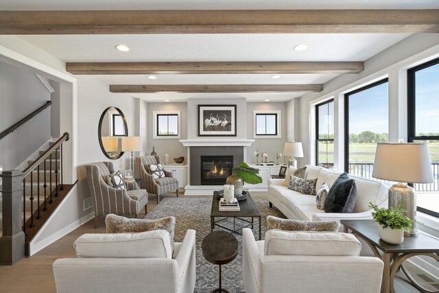 living room with beamed ceiling and wood-type flooring