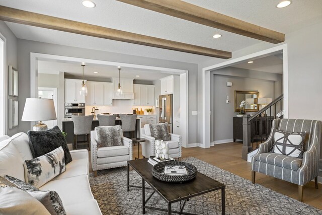 living room featuring wood-type flooring and beam ceiling