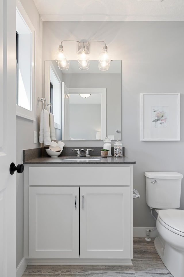 bathroom featuring vanity and toilet