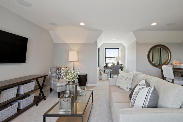 carpeted living room with vaulted ceiling