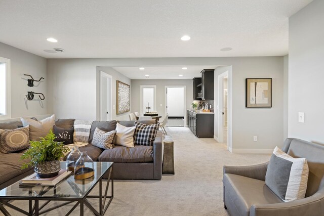 carpeted living room featuring plenty of natural light