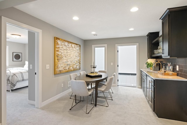 carpeted dining room featuring sink