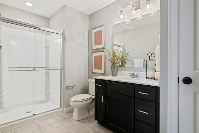 bathroom featuring tile patterned floors, a shower with shower door, toilet, and vanity