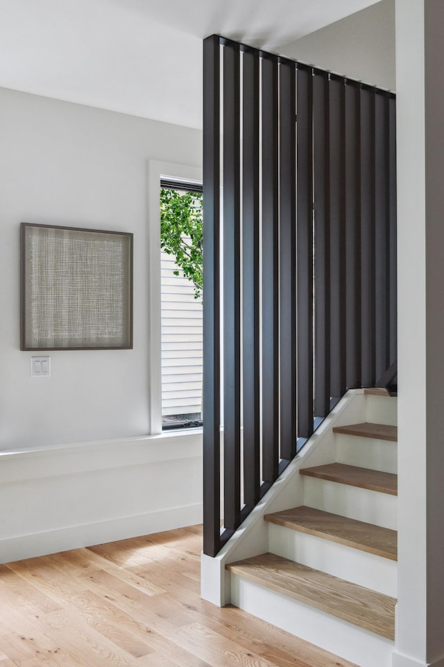 stairs featuring hardwood / wood-style floors