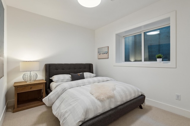 bedroom featuring light colored carpet