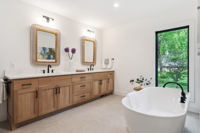 bathroom featuring vanity and a tub to relax in