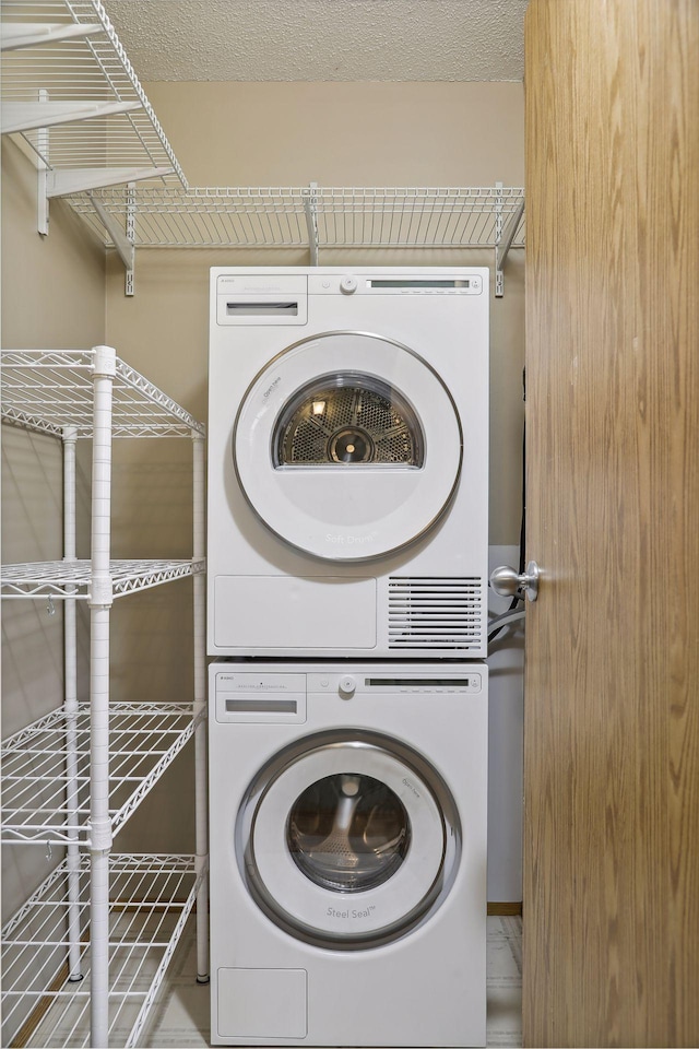 laundry area featuring stacked washer / dryer