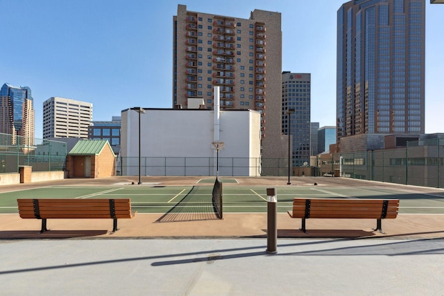 view of property's community featuring tennis court