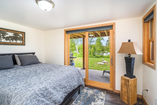 bedroom with dark hardwood / wood-style floors and access to outside