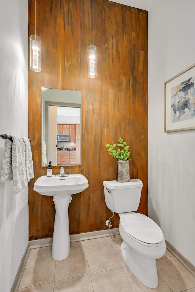 bathroom with tile patterned flooring and toilet