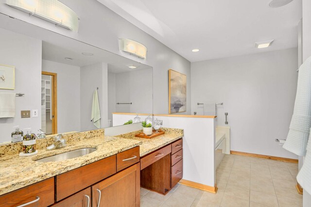 bathroom with a bathtub, tile patterned flooring, and vanity