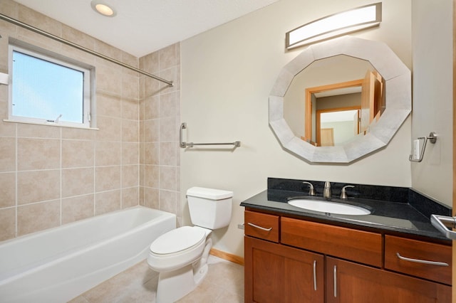 full bathroom featuring tile patterned floors, tiled shower / bath combo, vanity, and toilet